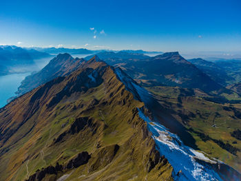 Scenic view of mountains against blue sky