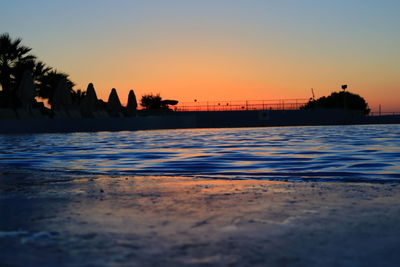 Scenic view of swimming pool against sky during sunset
