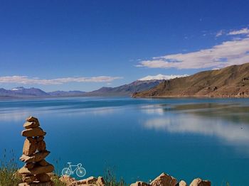 Scenic view of lake against blue sky