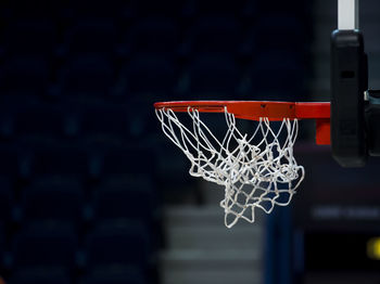 Close-up of basketball hoop hanging on sports court
