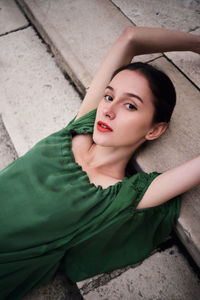 High angle portrait of woman lying on floor