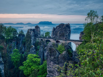 View of arch bridge against cloudy sky