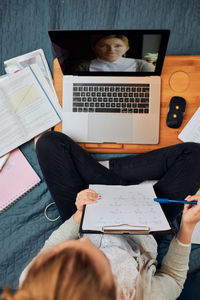 Young woman student having classes, learning online, watching lesson remotely