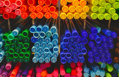 Close-up of colorful pens on rack for sale