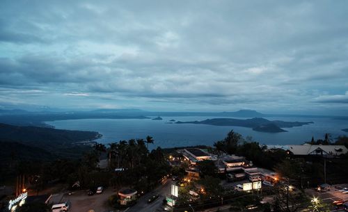 High angle view of houses by sea against sky