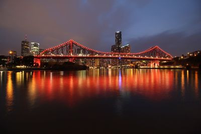 Illuminated golden gate bridge over river at night