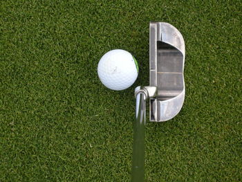 High angle view of ball and golf club at course