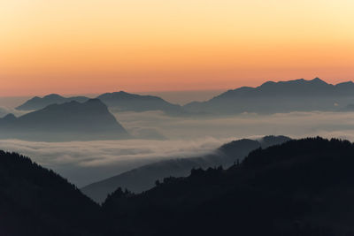 Scenic view of silhouette mountains against sky during sunset