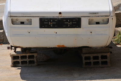 Close-up of abandoned car on road