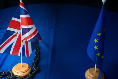 Close-up of flags with chain on table