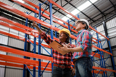 Low angle view of people working at construction site