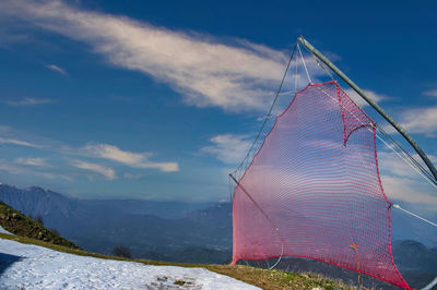 Ski slope in the mountains. on the side, red safety nets are installed