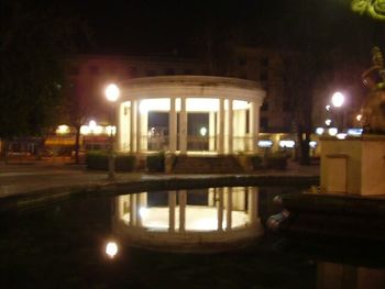 Illuminated fountain at night