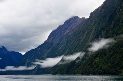 Scenic view of clouds and mountains against sky 