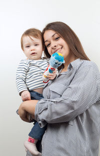 Mother and daughter against white background