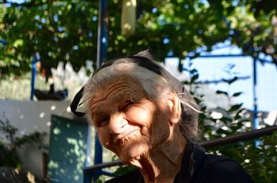 Portrait of woman smiling while sitting outdoors