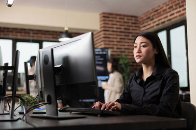 Young woman using laptop at office