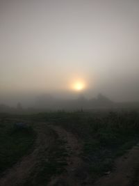 Scenic view of field against sky during sunset