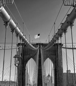 Low angle view of suspension bridge against sky