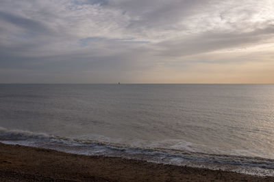 Scenic view of sea against cloudy sky