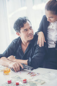 Man and woman sitting on table