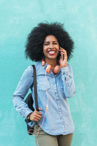 Portrait of smiling young woman using mobile phone