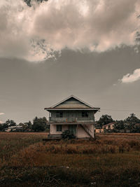 House on field against sky