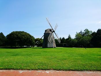 Traditional windmill on field against sky