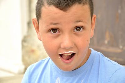 Close-up portrait of boy with milk mustache