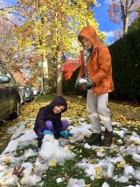 Man and woman standing by plants during winter