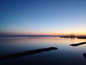 Scenic view of sea against clear sky during sunset