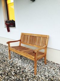High angle view of empty chairs and table against wall