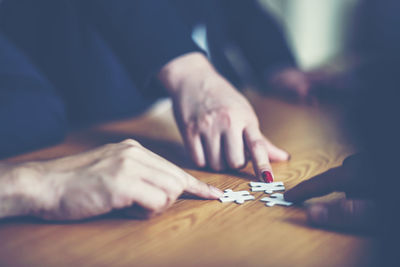 Close-up of man playing guitar on table