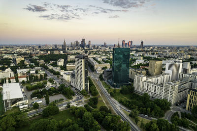 Warsaw, city centre panorama at sunset, business centre 2022. sunset reflected in buildings.