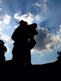 Low angle view of silhouette statue against sky during sunset