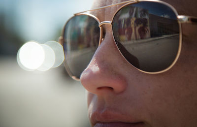 Close-up of mid adult woman wearing sunglasses during sunny day