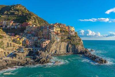 Scenic view of sea and buildings against sky