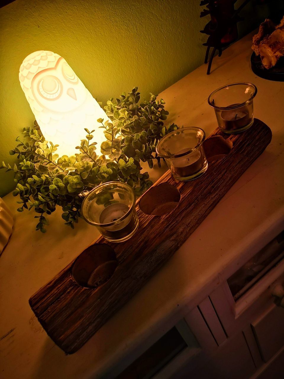 HIGH ANGLE VIEW OF POTTED PLANT ON TABLE AT ILLUMINATED CAFE