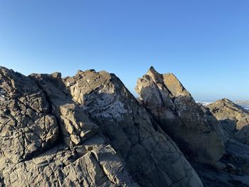 Rock formations against clear blue sky