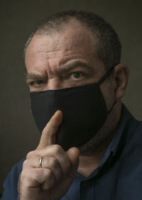 Close-up portrait of man covering face