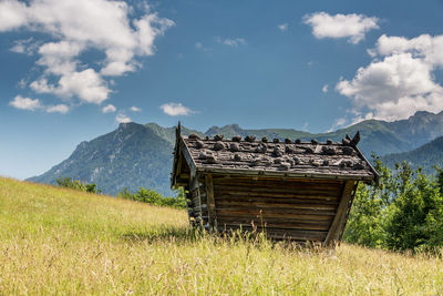 Built structure on field against sky