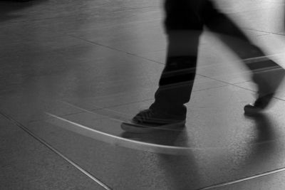 Low section of person standing on tiled floor