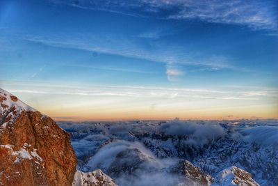 Scenic view of snowcapped mountains against sky during sunset