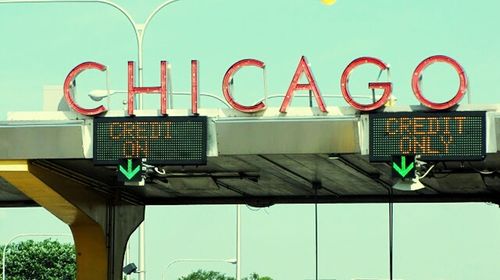 Low angle view of sign board against blue sky