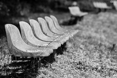 Close-up of empty bench in field