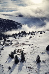 Scenic view of snow covered land against sky