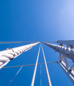 Low angle view of bridge against clear blue sky