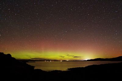 Scenic view of landscape against star field