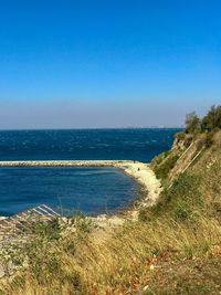 Scenic view of sea against clear blue sky