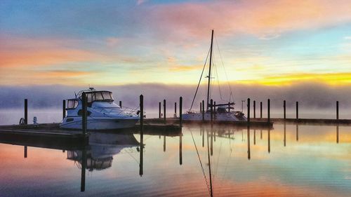 Yacht moored at lake against sky during dusk